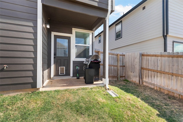 entrance to property featuring a lawn