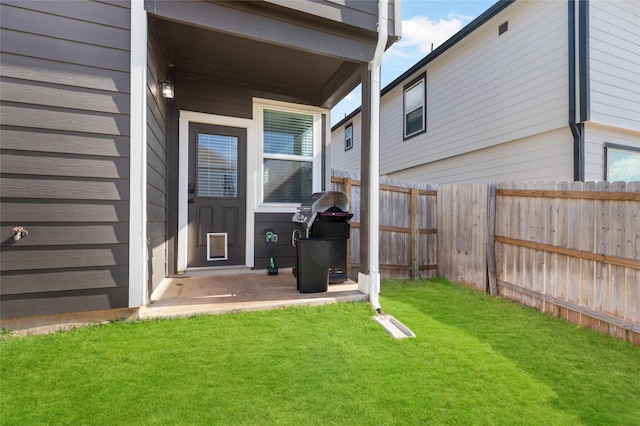 view of exterior entry with a lawn