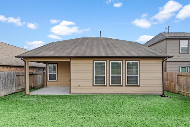 rear view of house featuring a lawn and a patio