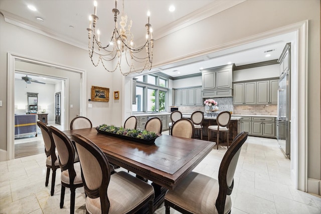 dining space with ceiling fan with notable chandelier and ornamental molding