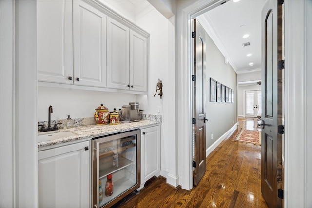 bar with ornamental molding, sink, white cabinets, dark hardwood / wood-style floors, and wine cooler