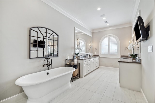 bathroom with a tub to relax in, ornamental molding, vanity, a notable chandelier, and tile patterned flooring