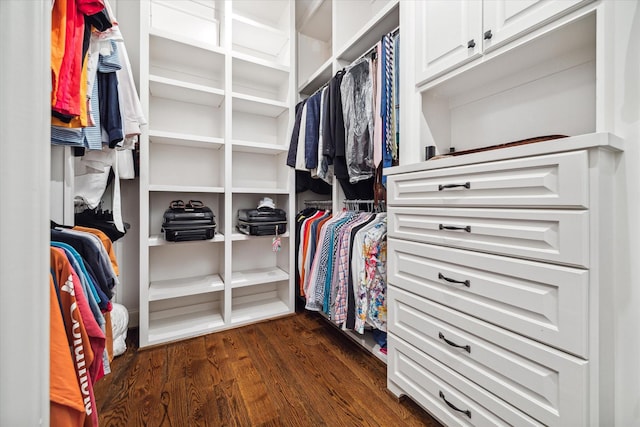 walk in closet with dark wood-type flooring