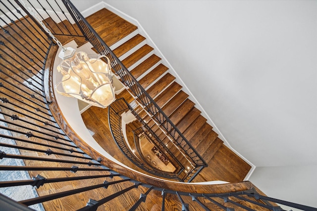 stairs with an inviting chandelier