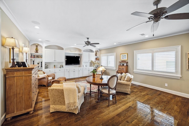 living room featuring built in shelves, dark hardwood / wood-style floors, and ornamental molding