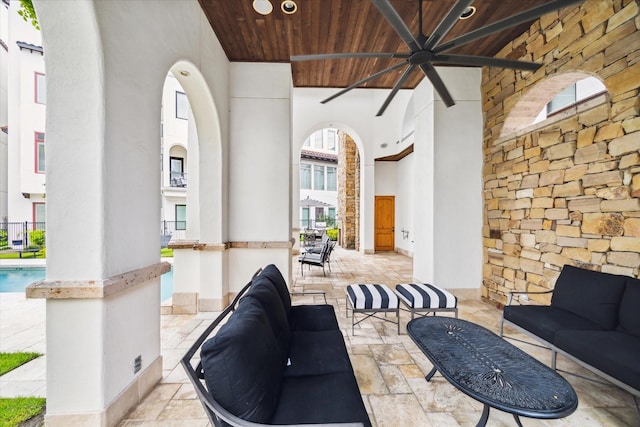 interior space with an outdoor hangout area and ceiling fan