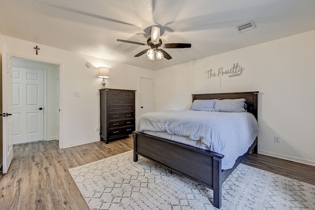 bedroom with ceiling fan and light hardwood / wood-style floors