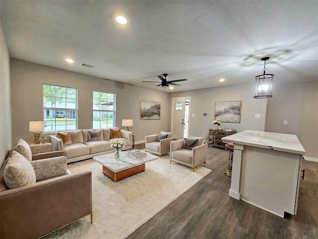 living room featuring dark hardwood / wood-style floors and ceiling fan