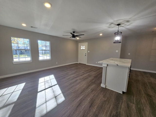 interior space featuring ceiling fan and dark hardwood / wood-style floors