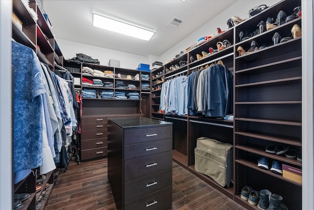 walk in closet with visible vents and dark wood-style flooring