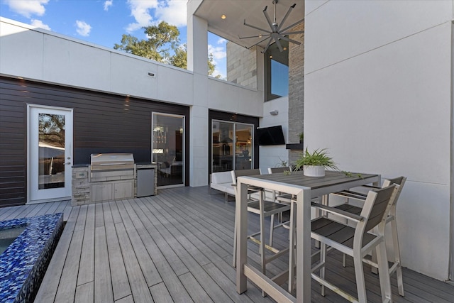 deck with ceiling fan, outdoor dining area, grilling area, and area for grilling