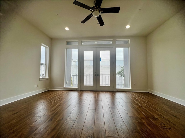 unfurnished room with ceiling fan, dark hardwood / wood-style floors, and french doors