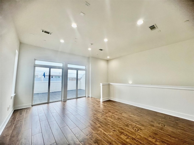 unfurnished room with dark wood-type flooring