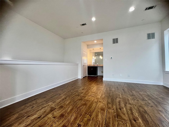 spare room with dark hardwood / wood-style floors