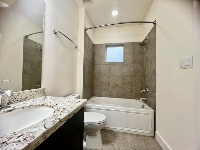 full bathroom with vanity, tiled shower / bath combo, and toilet