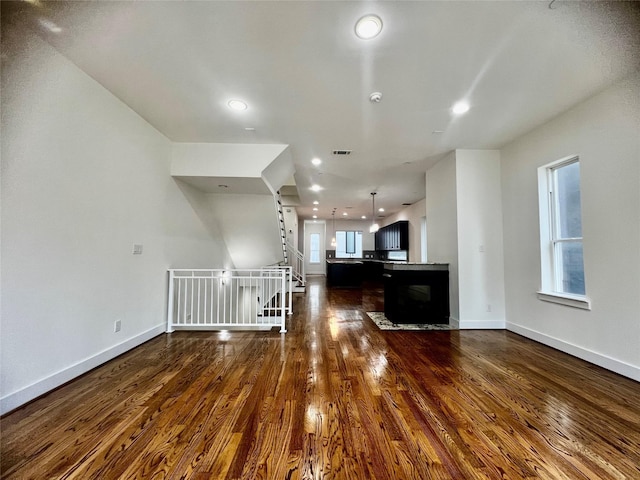 unfurnished living room featuring dark hardwood / wood-style flooring