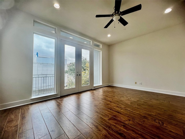 spare room featuring french doors, ceiling fan, and dark wood-type flooring