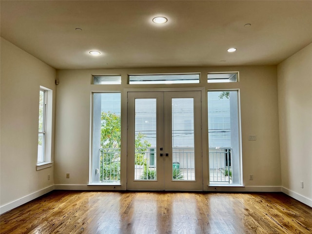 entryway with french doors and wood-type flooring