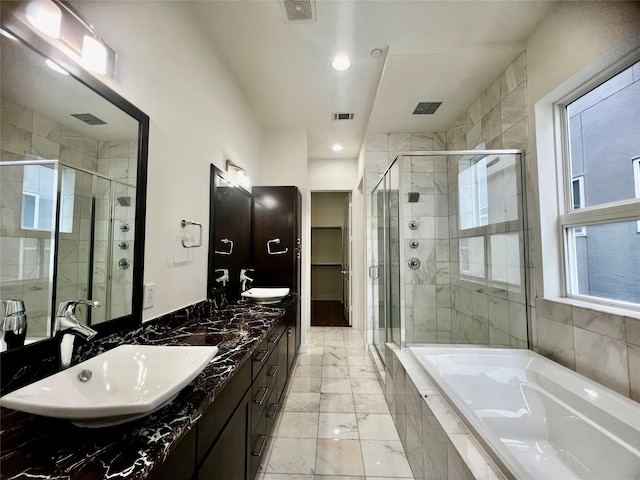 bathroom with vanity and separate shower and tub