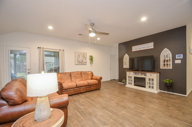 living room featuring ceiling fan and wood-type flooring