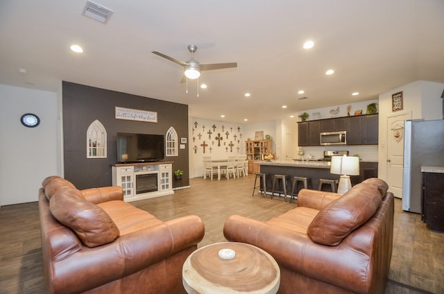 living room with ceiling fan and hardwood / wood-style flooring