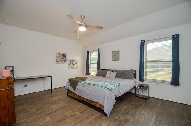 bedroom featuring dark hardwood / wood-style floors, vaulted ceiling, and ceiling fan