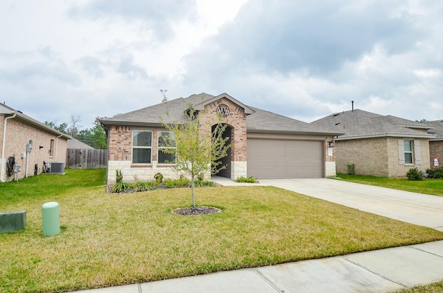 view of front of property featuring cooling unit, a garage, and a front yard