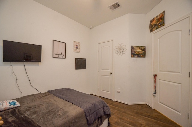 bedroom with dark hardwood / wood-style floors