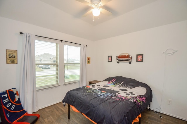 bedroom with ceiling fan and dark hardwood / wood-style floors