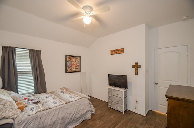 bedroom featuring ceiling fan, dark wood-type flooring, and vaulted ceiling