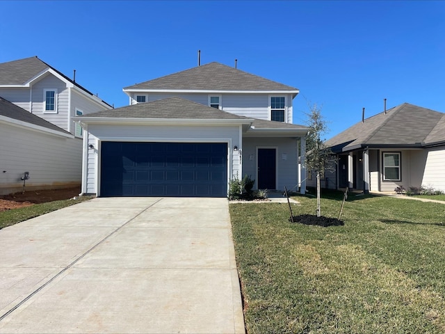 view of property with a garage and a front lawn