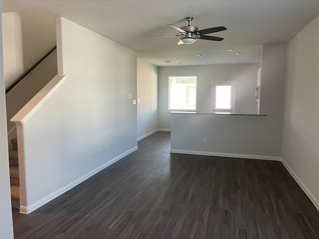 unfurnished room with ceiling fan and dark wood-type flooring