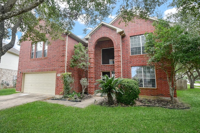 view of front of property featuring a front yard and a garage