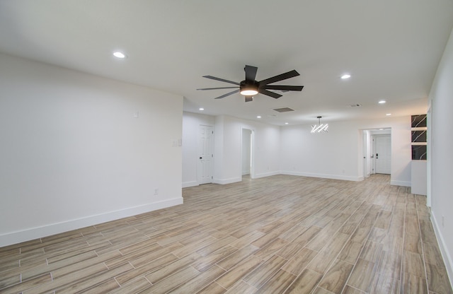 unfurnished living room with ceiling fan