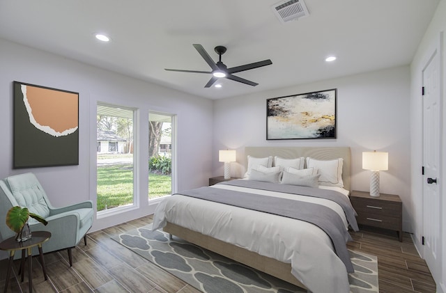 bedroom with ceiling fan and multiple windows