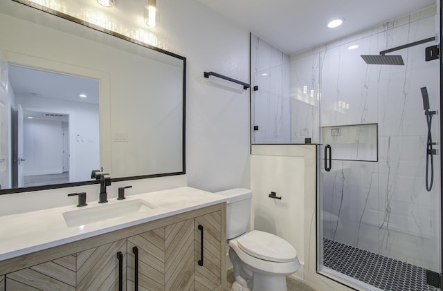 bathroom with vanity, toilet, and walk in shower