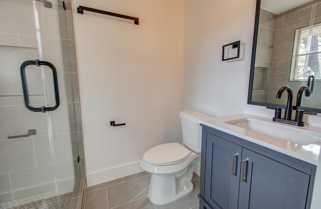 bathroom with tile patterned flooring, vanity, toilet, and a shower with door