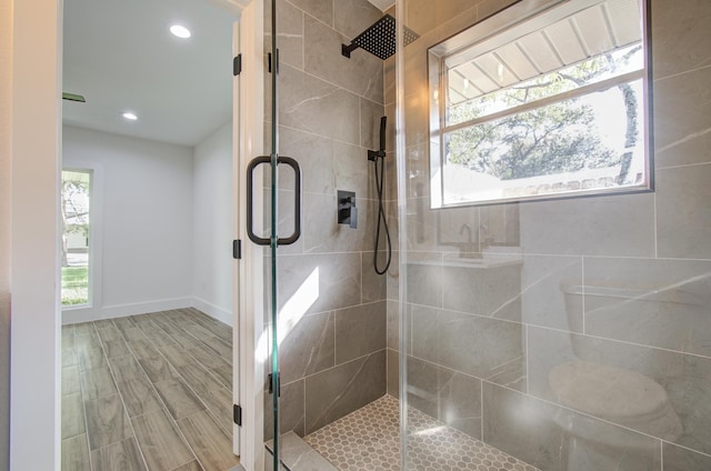 bathroom with wood-type flooring and walk in shower