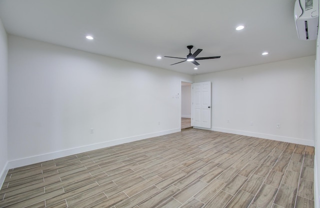 empty room with ceiling fan and a wall mounted air conditioner