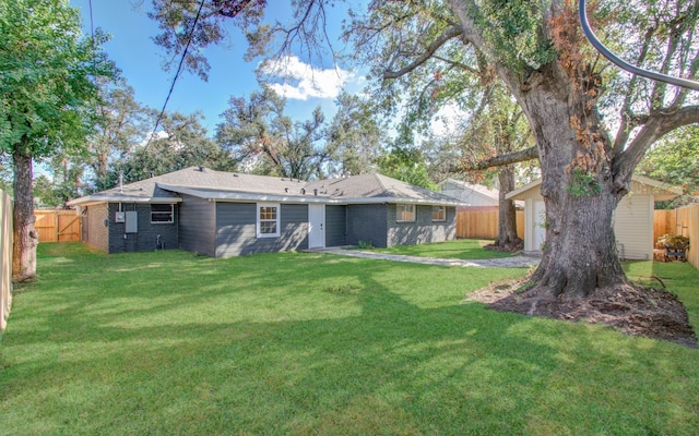 rear view of property featuring a lawn