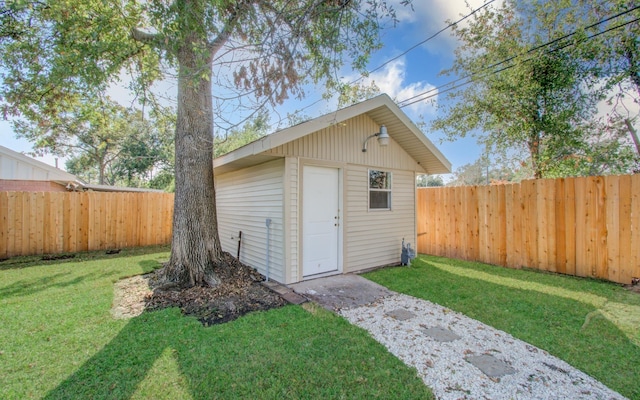 view of outbuilding featuring a lawn