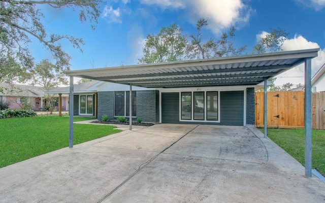 back of property with a yard and a carport