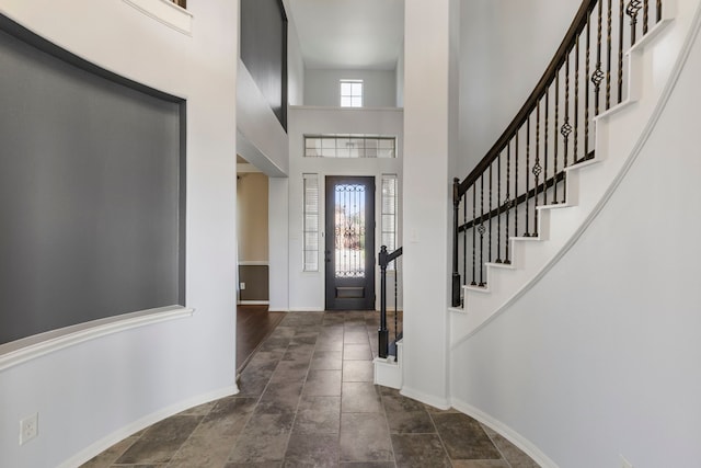 foyer entrance with a towering ceiling