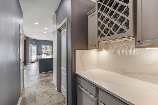 bar with gray cabinetry