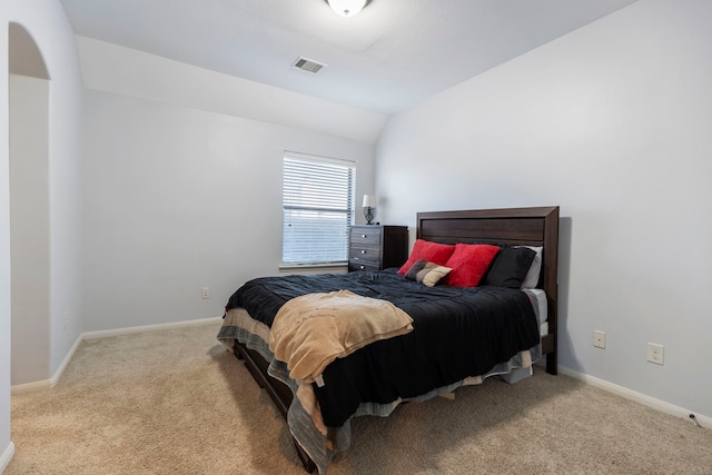 carpeted bedroom with vaulted ceiling