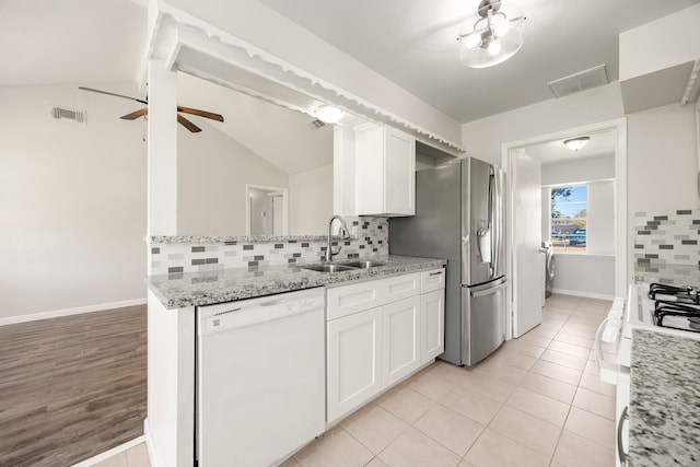 kitchen featuring white cabinets, dishwasher, decorative backsplash, and sink