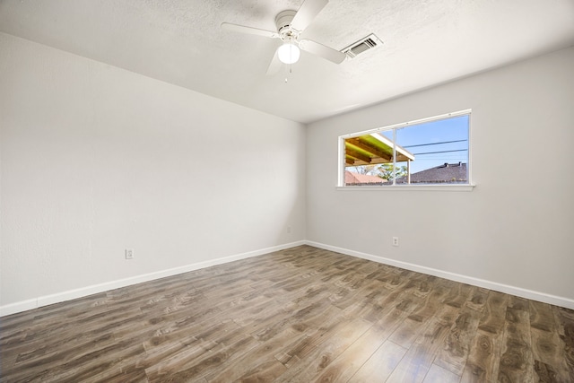 empty room featuring hardwood / wood-style floors and ceiling fan