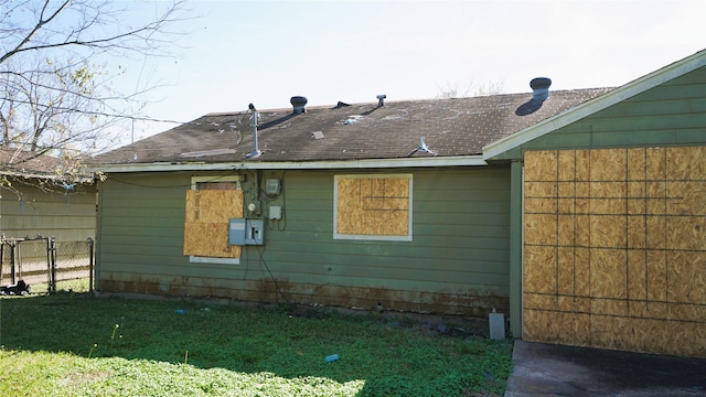 view of side of home with a yard