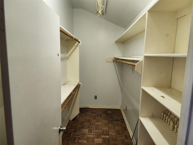 walk in closet featuring dark parquet flooring