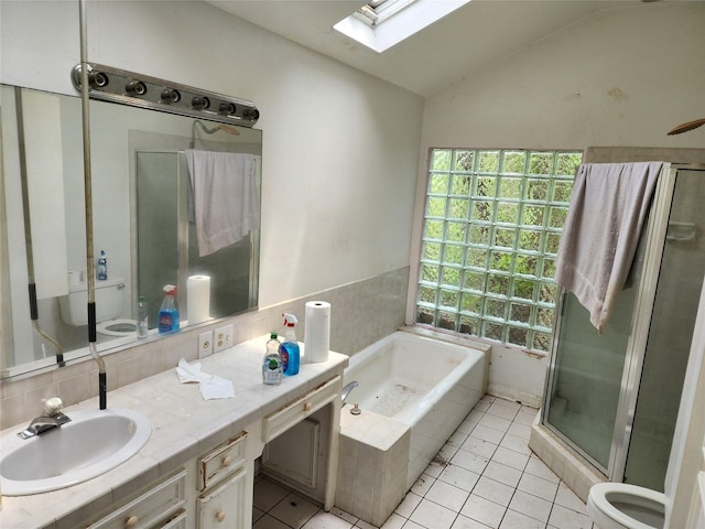 bathroom with tile patterned flooring, vanity, separate shower and tub, and lofted ceiling with skylight